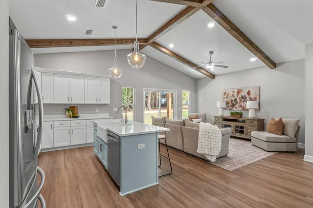 a living room with kitchen island furniture and a wooden floor