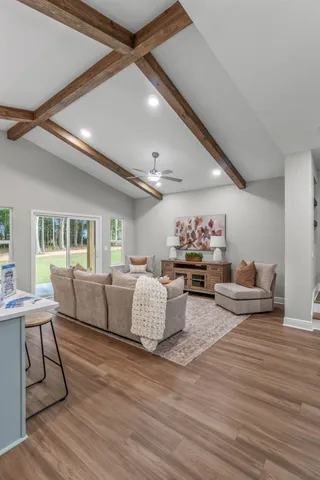 a living room with furniture and wooden floor
