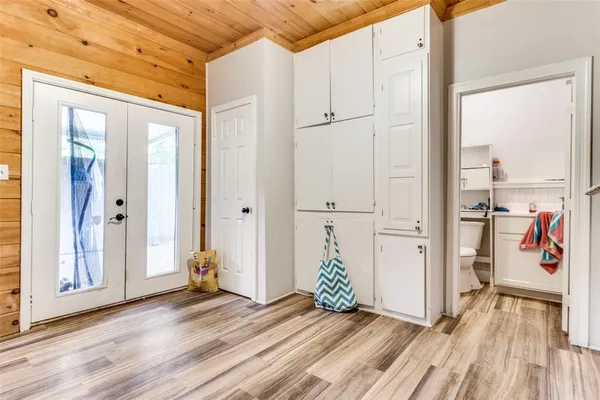 a view of a hallway with wooden floor and closet area