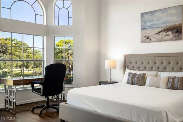 a bedroom with furniture and a large window