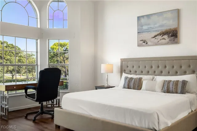 a bedroom with a bed and a chair