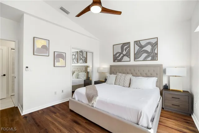 a bedroom with a bed and a painting on the wall