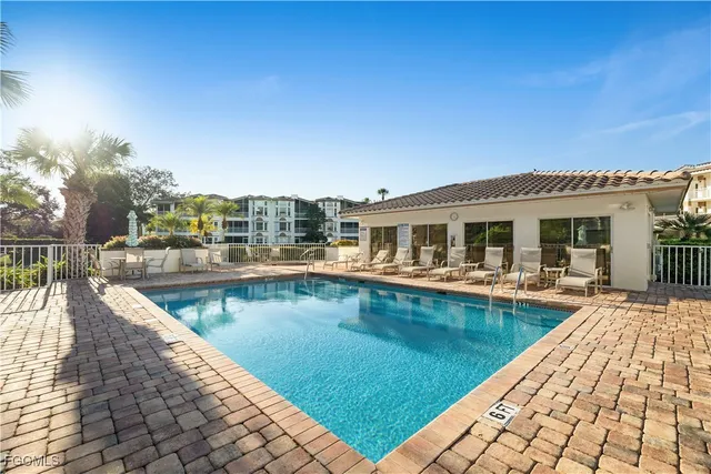 a view of a patio with swimming pool table and chairs
