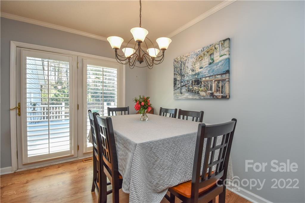 3403 Lake Shore Road South Denver, NC 28037 - Photo 12 of 37 a view of a dining room with furniture a chandelier and wooden floor
