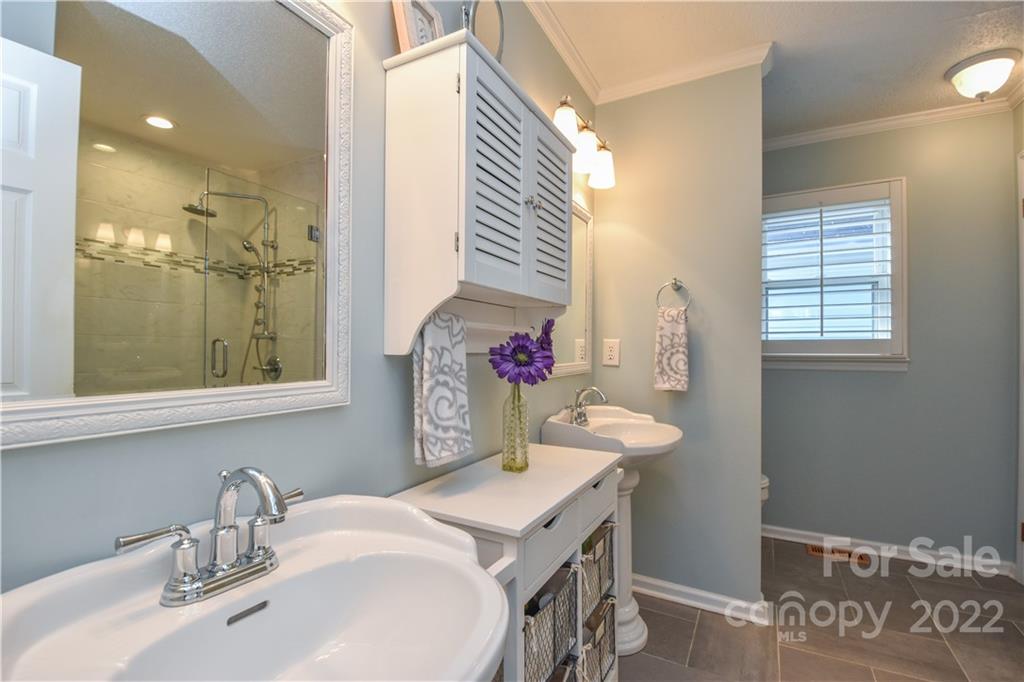 3403 Lake Shore Road South Denver, NC 28037 - Photo 17 of 37 a bathroom with a sink mirror and a shower
