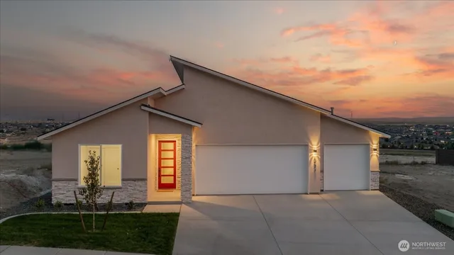 a backyard of a house with lots of green space and plants