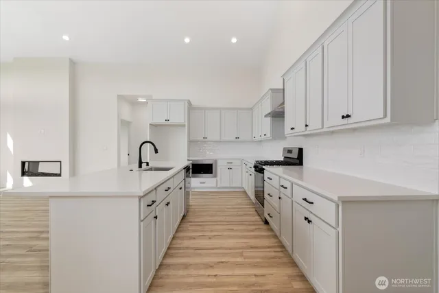 a kitchen with white cabinets