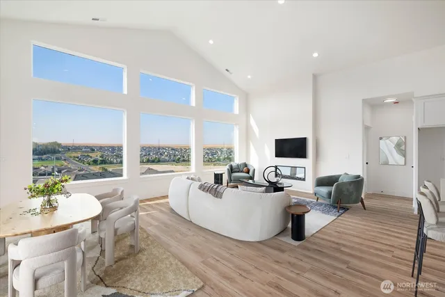 a living room with furniture large window and a flat screen tv