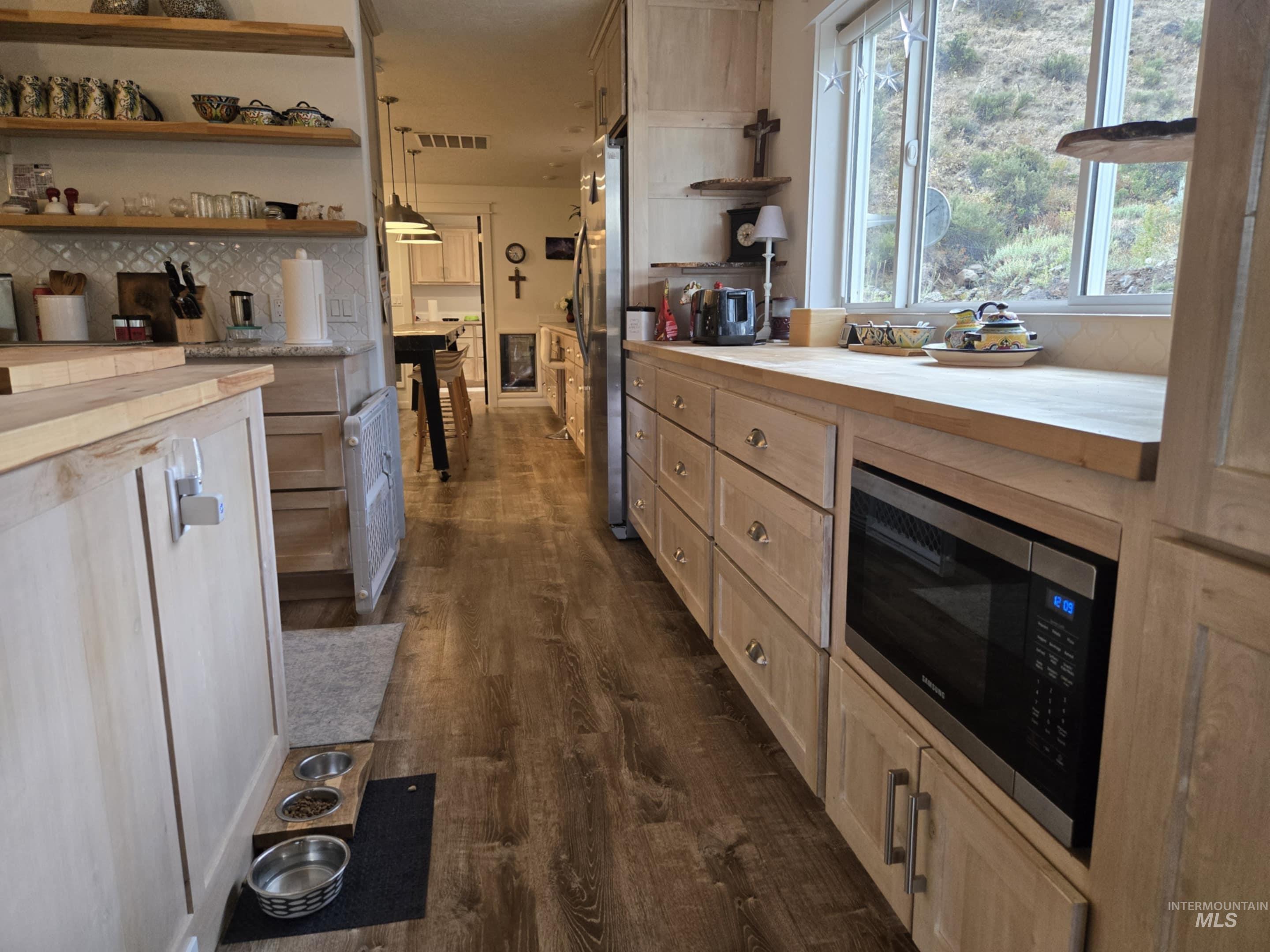 2141 Jackson Creek Road Council, ID 83612 - Photo 12 of 45 More butcher block countertops extend the workspace, while a second refrigerator adds convenience. Just beyond, a dedicated craft room with its own perfect crafting table