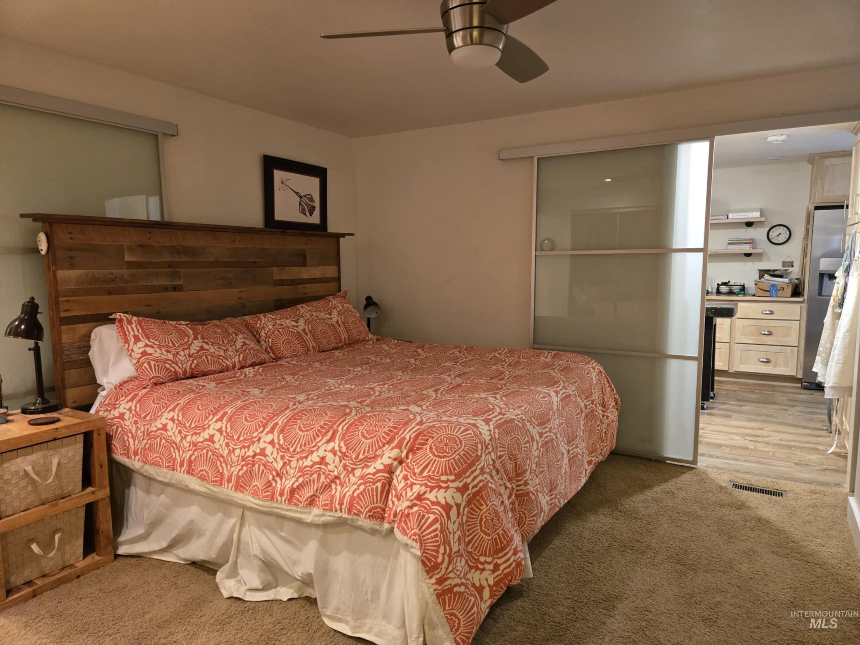 2141 Jackson Creek Road Council, ID 83612 - Photo 21 of 45 The primary bedroom feels both modern and inviting, featuring oversized frosted glass barn-style sliding doors that provide privacy with a touch of style