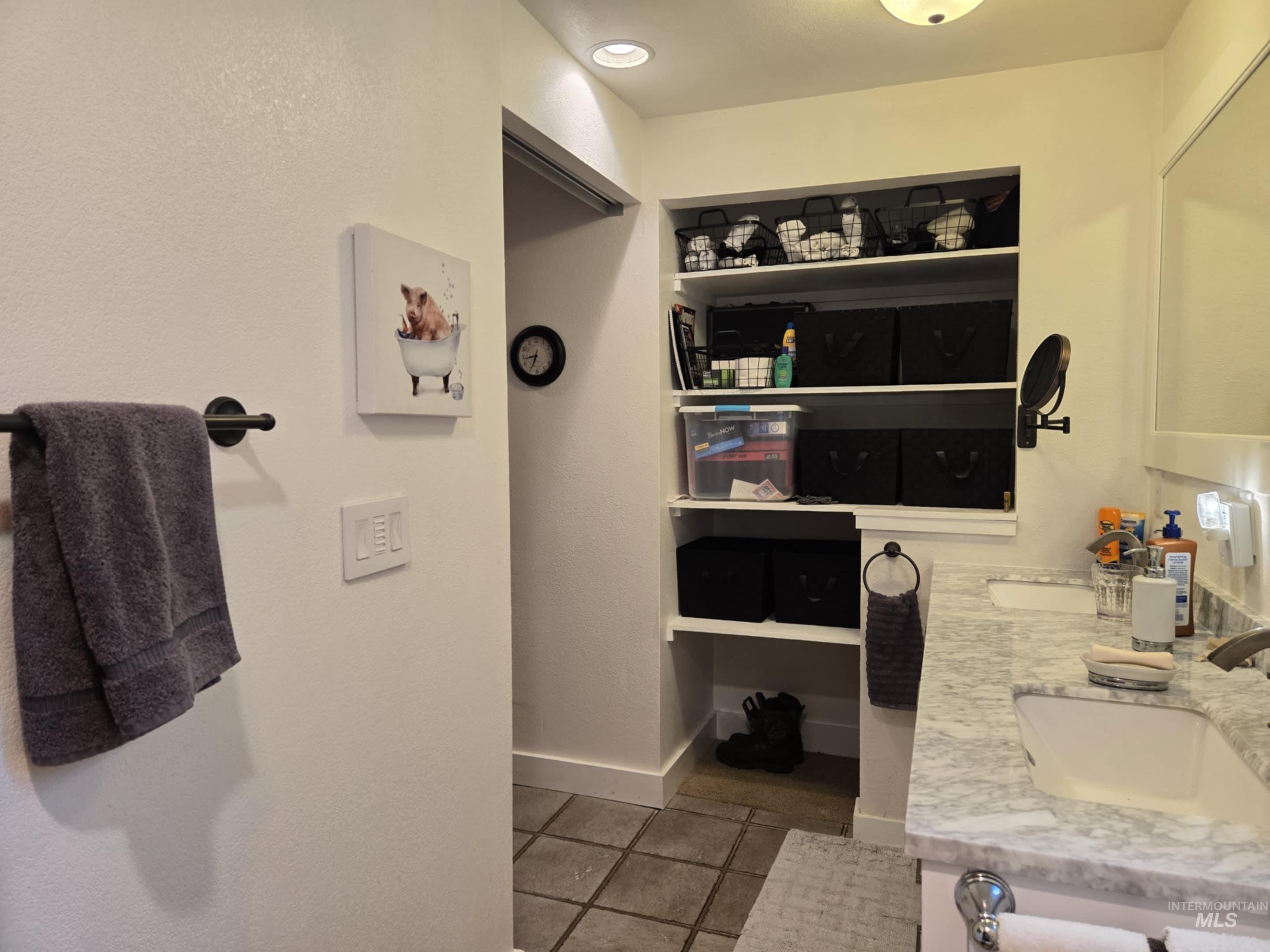 2141 Jackson Creek Road Council, ID 83612 - Photo 22 of 45 The primary bathroom features open shelving, keeping essentials close at hand while adding a stylish, airy feel