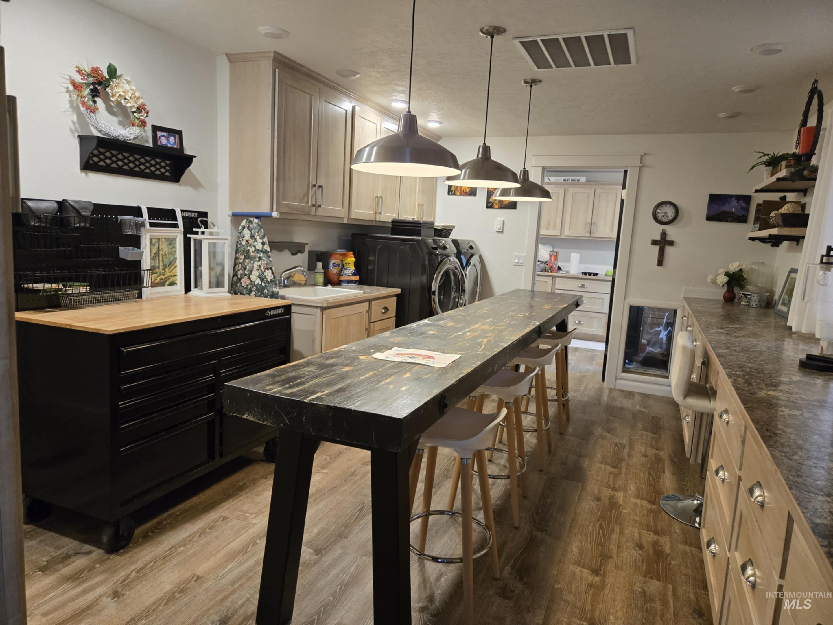 2141 Jackson Creek Road Council, ID 83612 - Photo 26 of 45 The laundry/craft room is as functional as it is versatile, with a utility sink and storage galore to keep everything organized