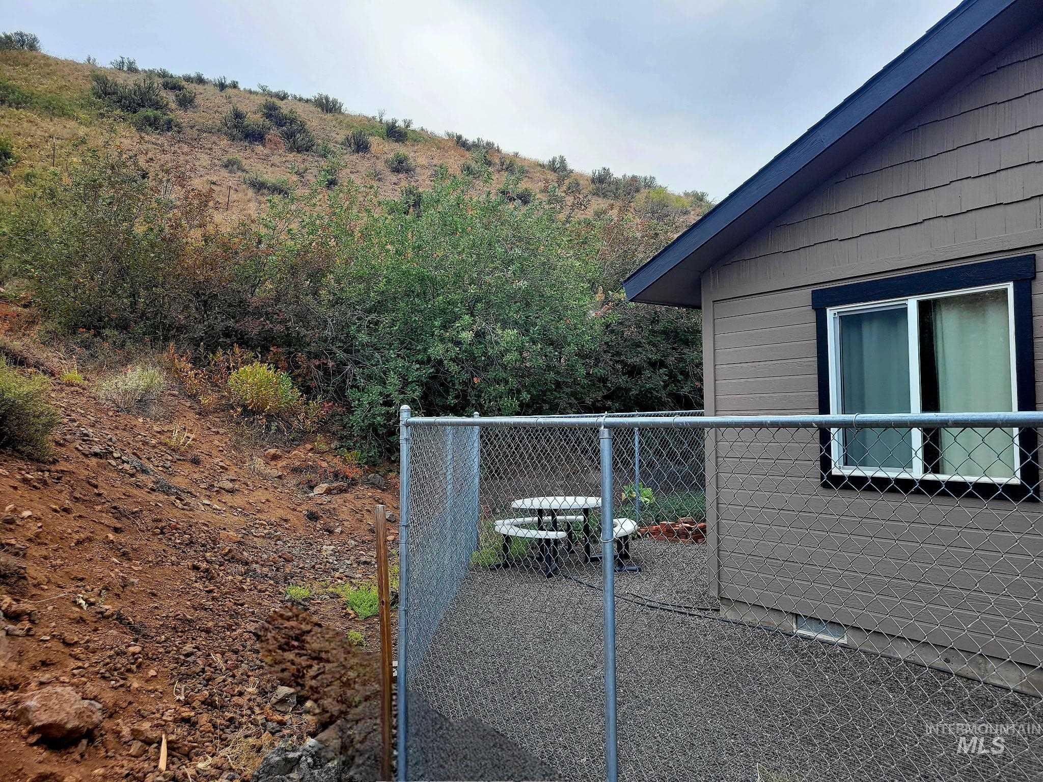 2141 Jackson Creek Road Council, ID 83612 - Photo 31 of 45 Pet owners will love the fenced and graveled dog run—easy to clean and perfect for keeping paws mud-free