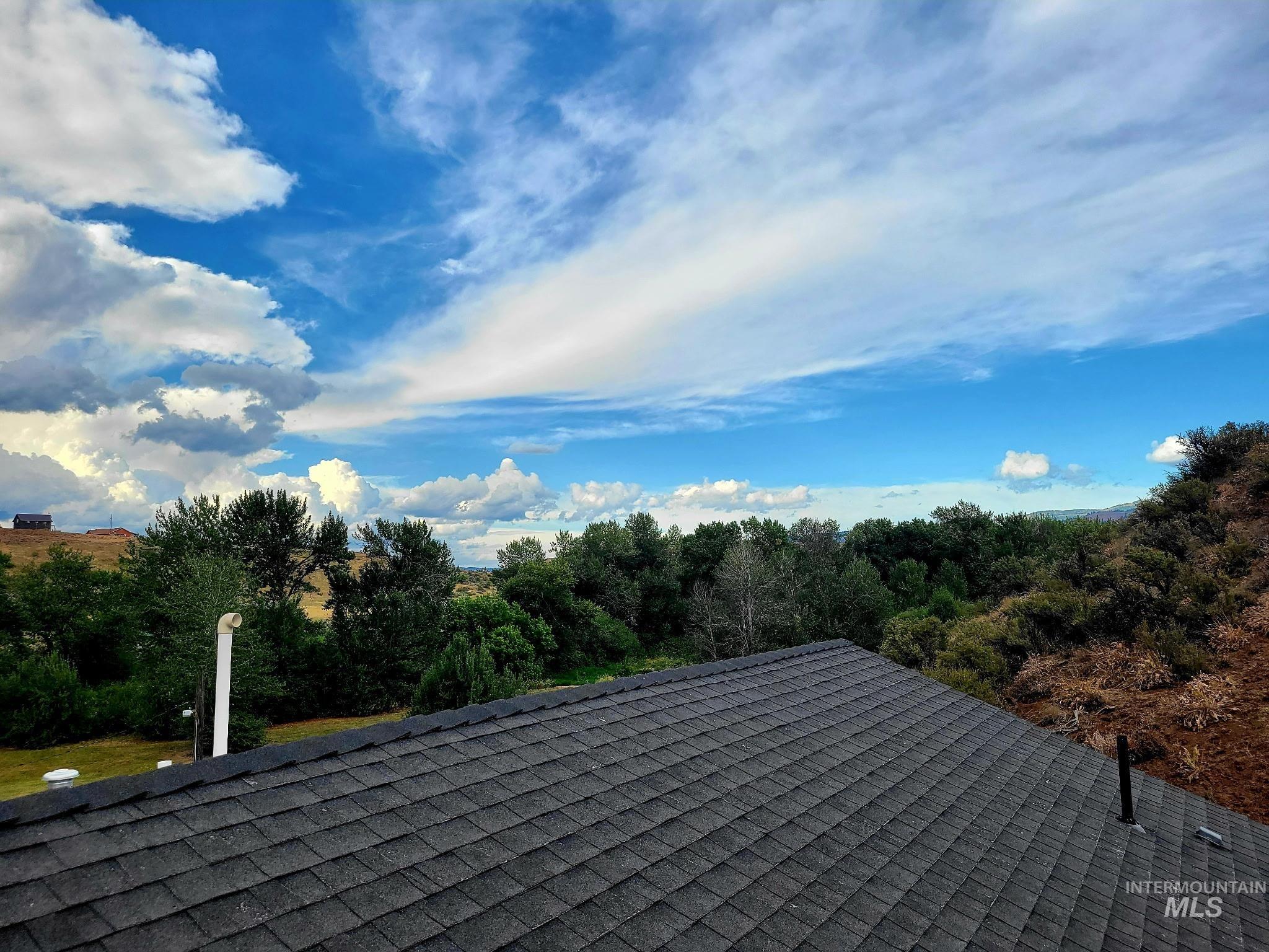 2141 Jackson Creek Road Council, ID 83612 - Photo 33 of 45 The roof is finished with beautiful composition tile, and its gentle slope allows for easy chimney access—and even a chance to take in the view while you’re there