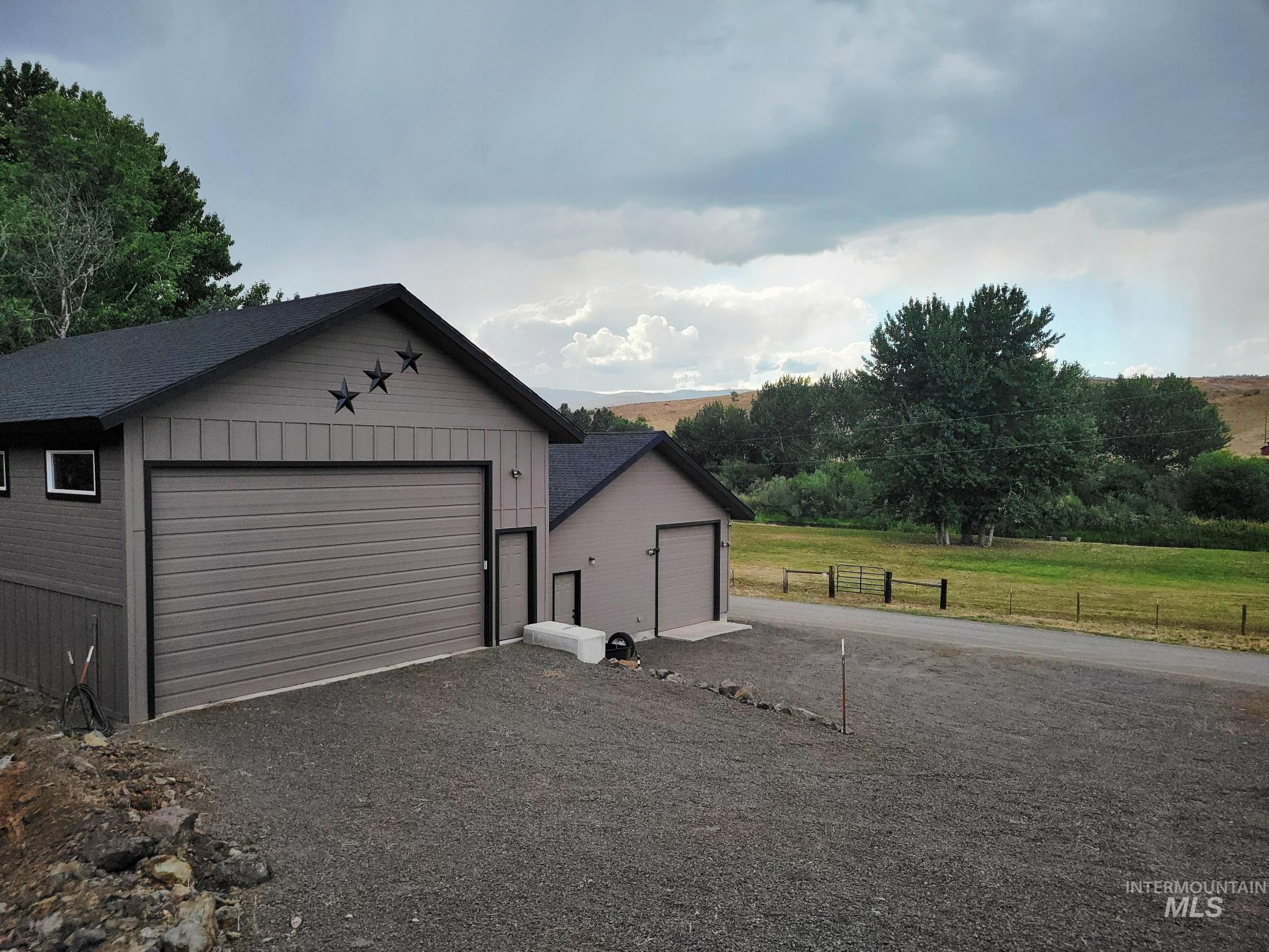 2141 Jackson Creek Road Council, ID 83612 - Photo 4 of 45 A detached garage with a gravel floor makes storing wet, snowy vehicles and equipment simple and low-maintenance. Just below, the bunkhouse and an additional garage with a concrete floor offer perfect space for your UTV and outdoor sporting gear