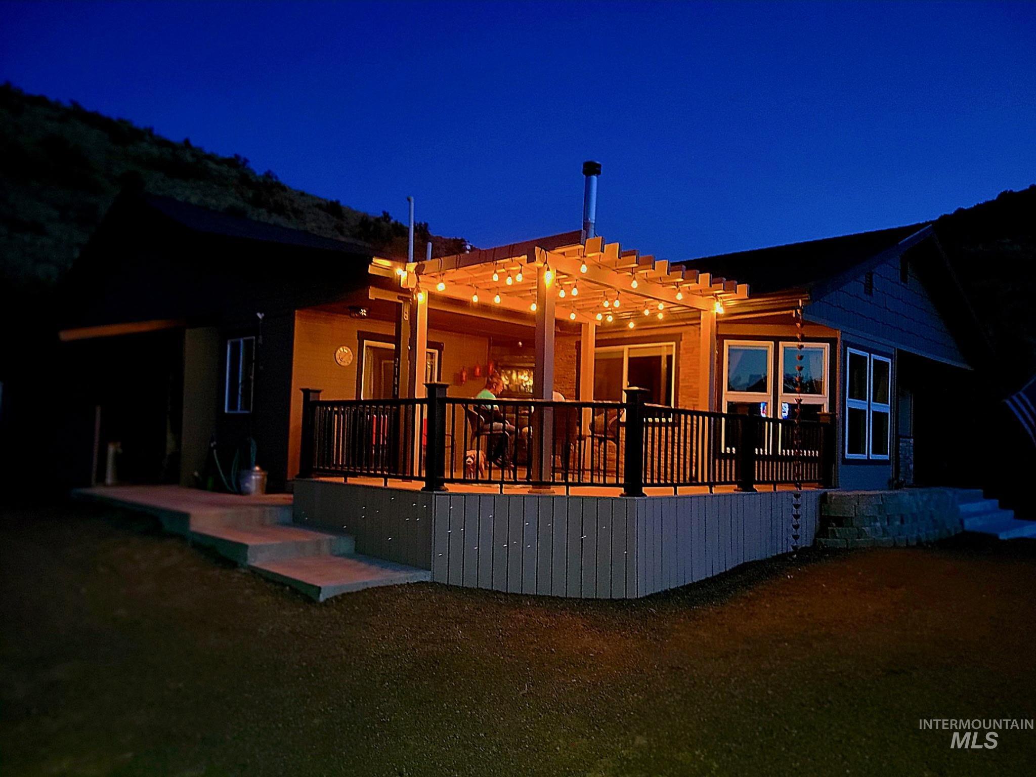 2141 Jackson Creek Road Council, ID 83612 - Photo 5 of 45 House at twilight featuring a wooden deck great for hosting get togethers or just relaxing