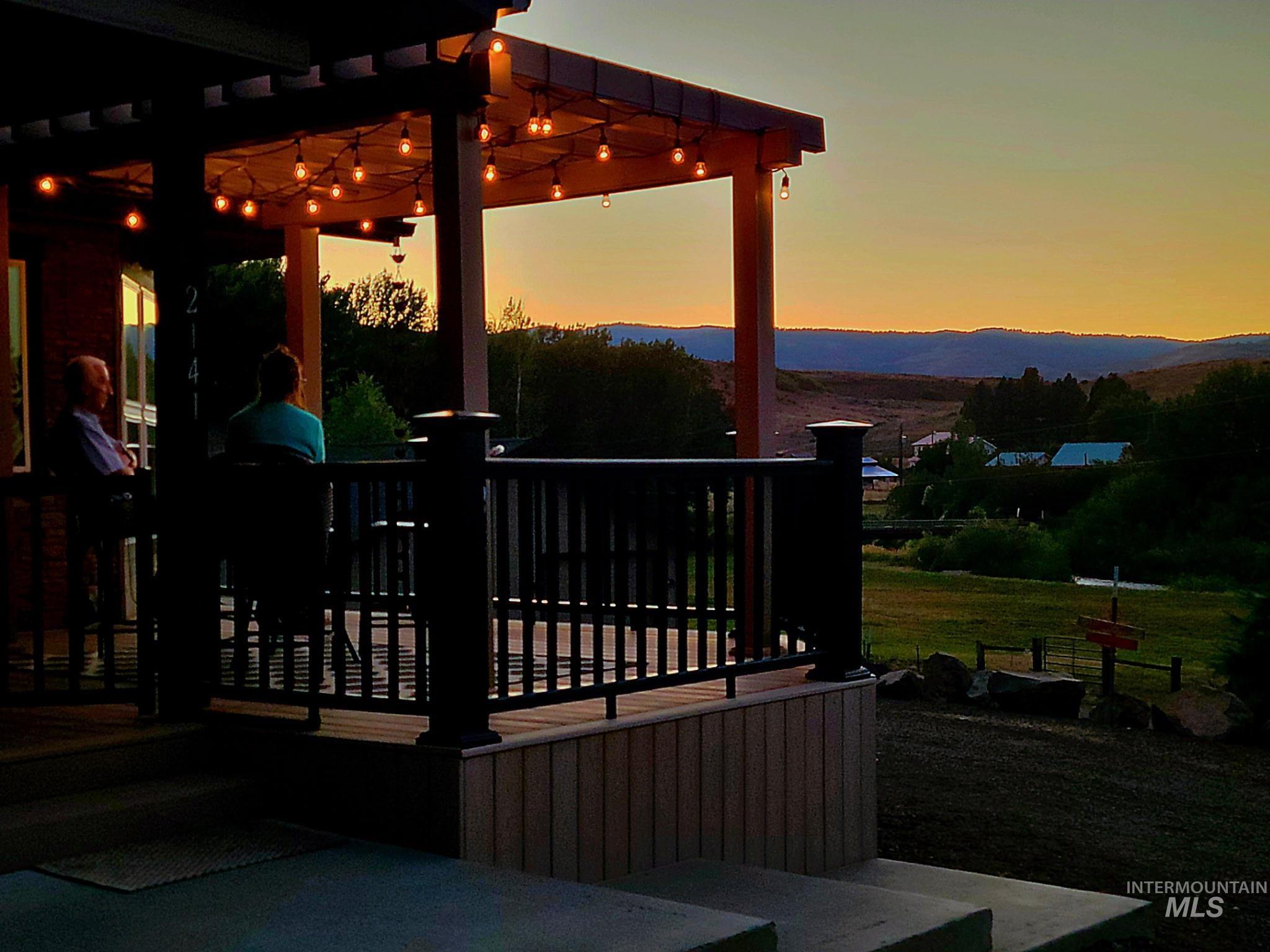2141 Jackson Creek Road Council, ID 83612 - Photo 6 of 45 At dusk, the deck glows with mountain and river views. Ideal for coffee at sunrise or a glass of wine under the stars