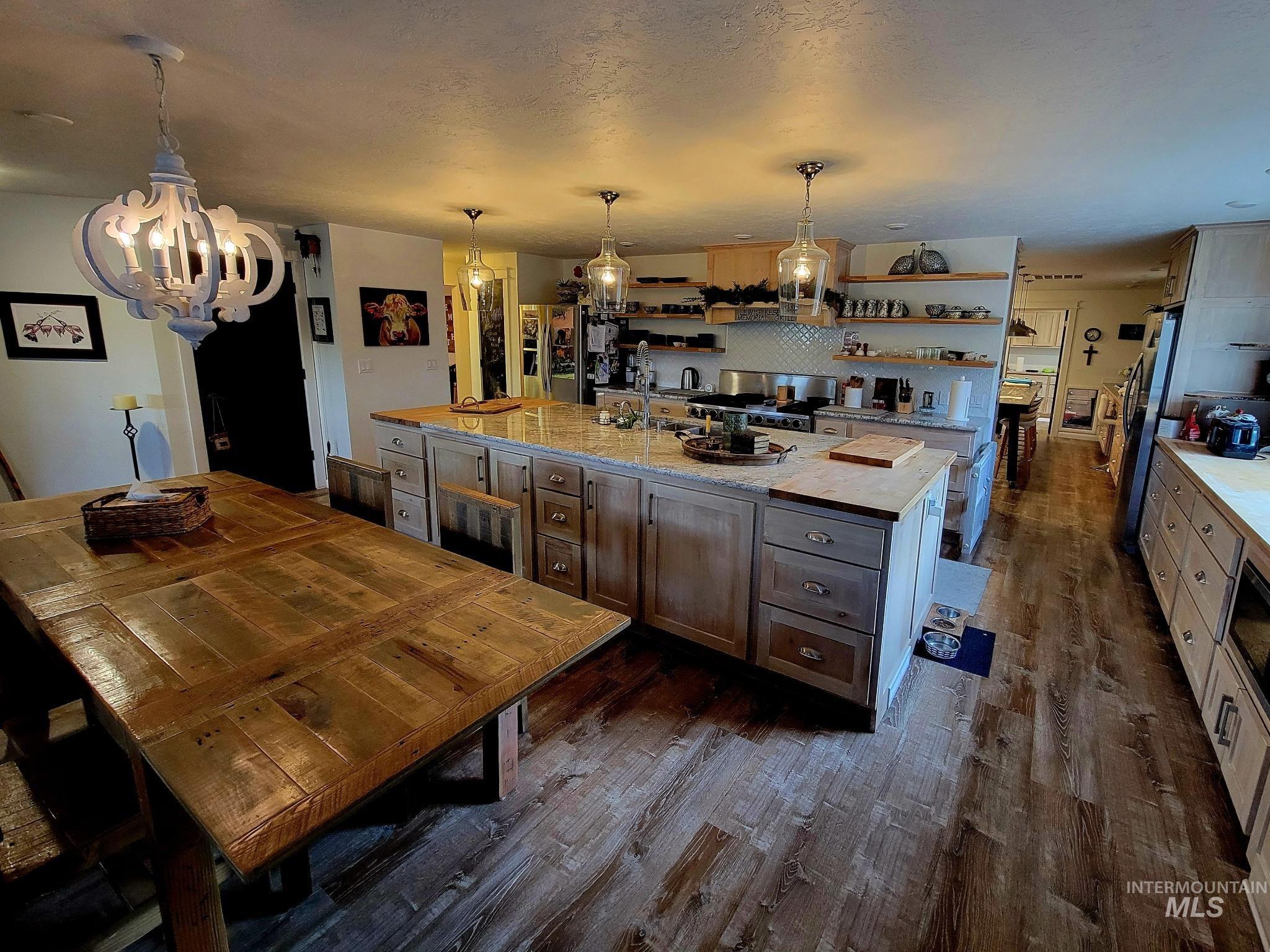 2141 Jackson Creek Road Council, ID 83612 - Photo 9 of 45 Meals turn into memories in a kitchen that offers both a big island for prep and a dining table fit for gatherings and storage for everything you need