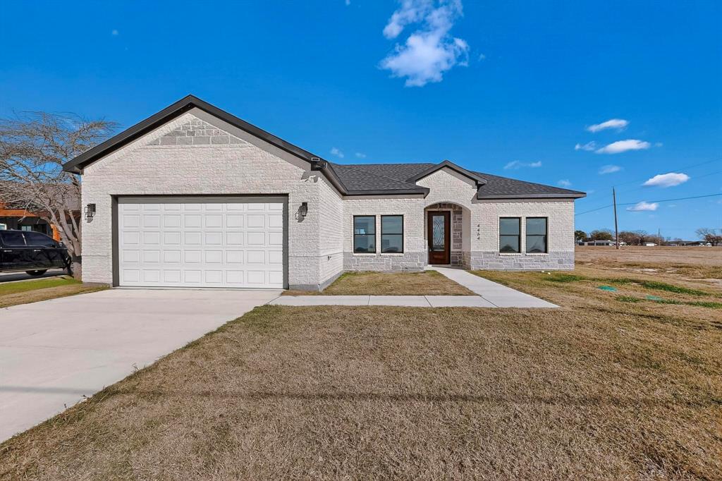 4464 Key Ranch Road Trinidad, TX 75163 - Photo 2 of 40 View of front facade featuring a front yard, driveway, an attached garage, and brick siding