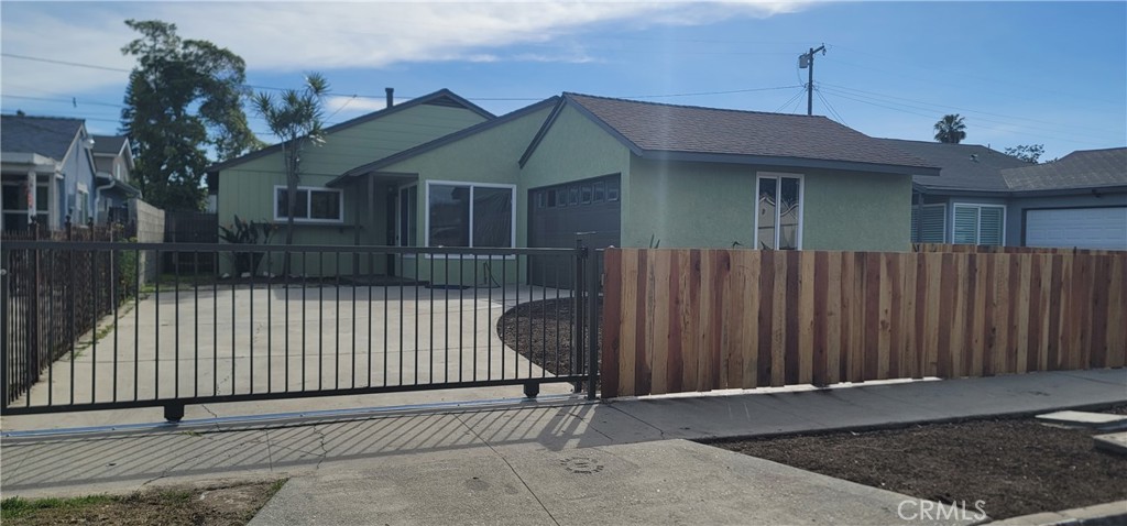 720 West 137th Street Compton, CA 90222 - Photo 1 of 5 a front view of a house with a garage