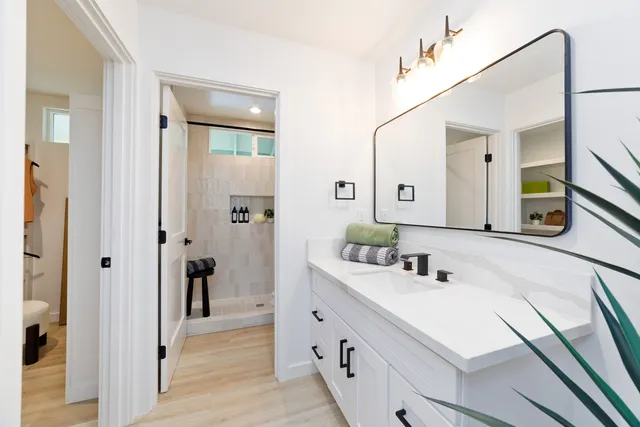 a bathroom with a sink a vanity and a mirror