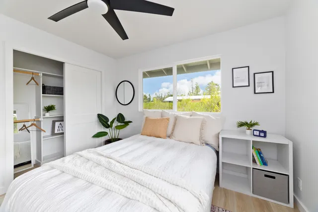 a bedroom with a bed and ceiling fan
