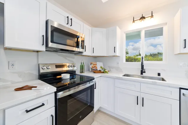 a kitchen with a sink stove and microwave