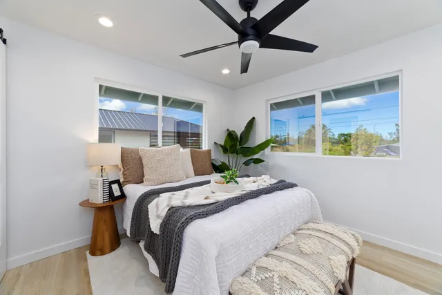 a bedroom with a bed and a painting on the wall