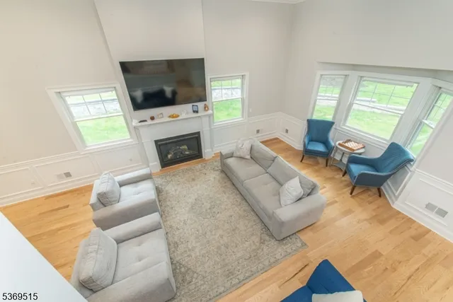 a living room with fireplace furniture and a flat screen tv