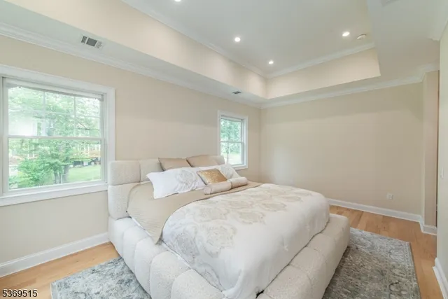 a bed room with a bed and a large window