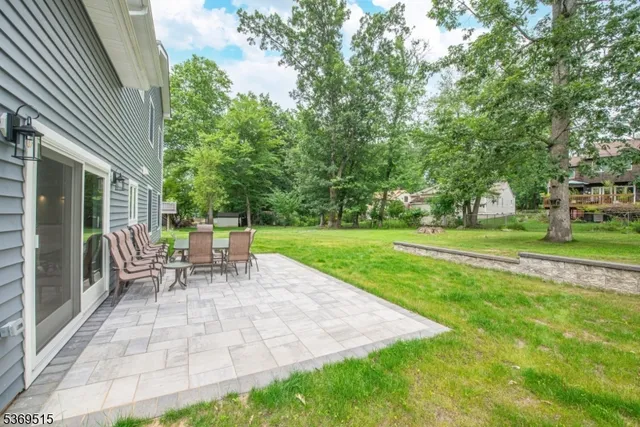 a view of a house with backyard and sitting area