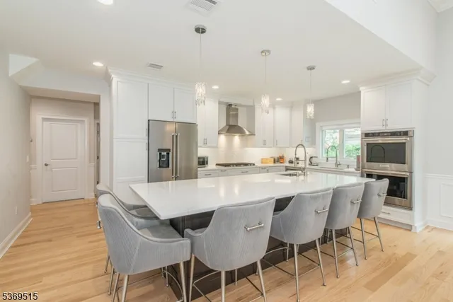 a large kitchen with a table and chairs