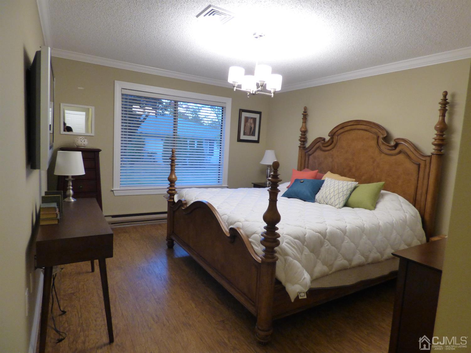 797B Sparta Road, Unit 797A Monroe Township, NJ 08831 - Photo 19 of 25 a bedroom with bed and wooden floor