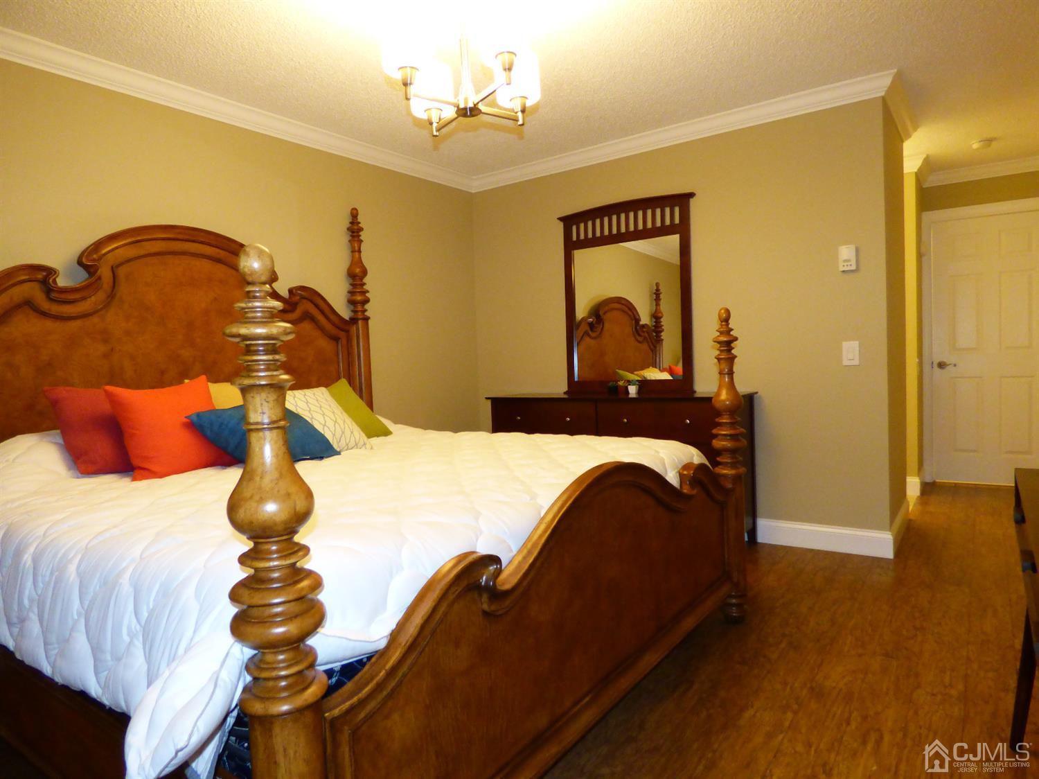 797B Sparta Road, Unit 797A Monroe Township, NJ 08831 - Photo 20 of 25 a bedroom with a bed and wooden floor