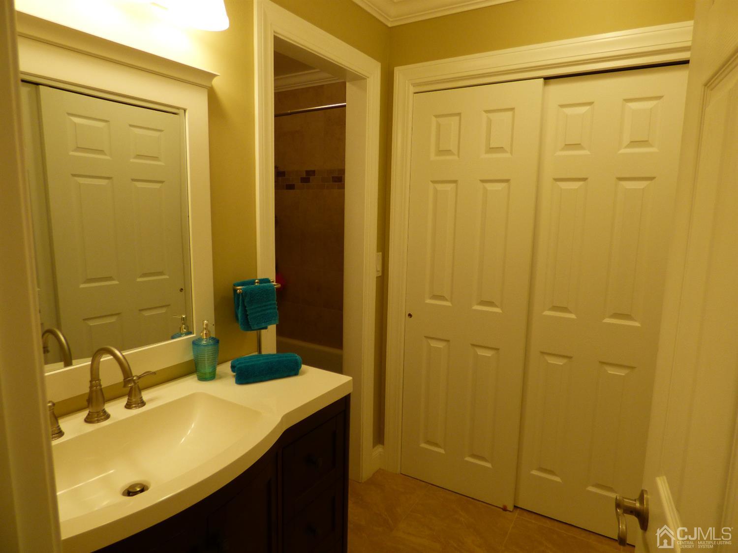 797B Sparta Road, Unit 797A Monroe Township, NJ 08831 - Photo 24 of 25 a bathroom with a sink a shower and a mirror