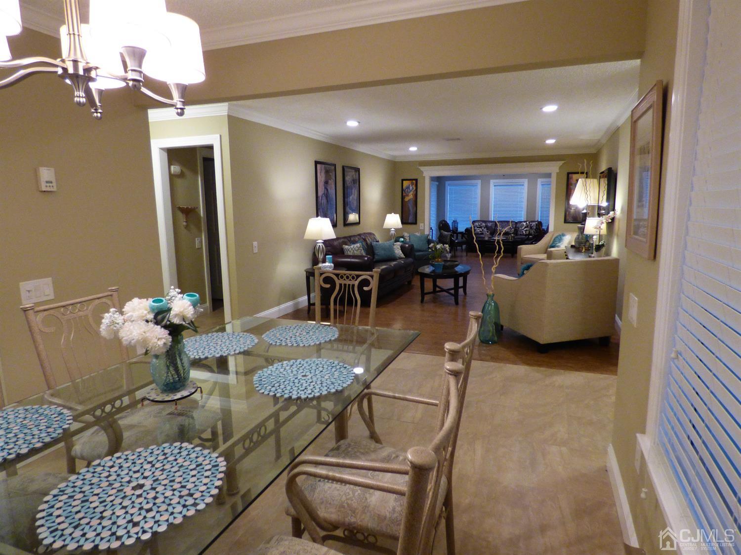 797B Sparta Road, Unit 797A Monroe Township, NJ 08831 - Photo 9 of 25 a living room with furniture and a dining table with potted plants
