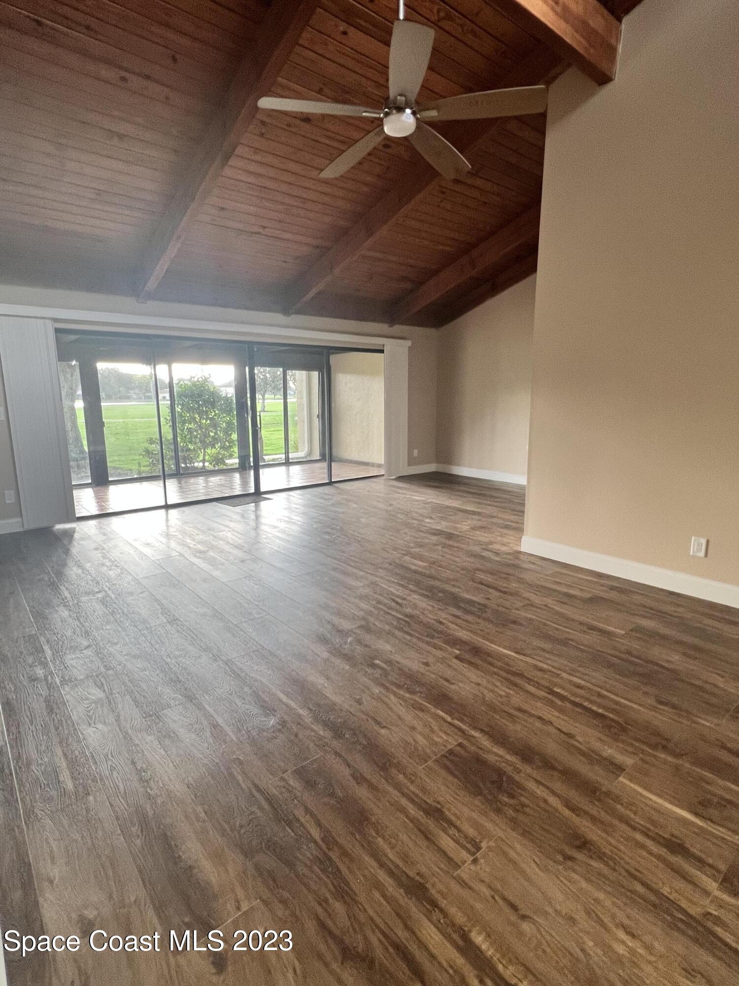 161 Augusta Way Melbourne, FL 32940 - Photo 6 of 26 an empty room with wooden floor and windows