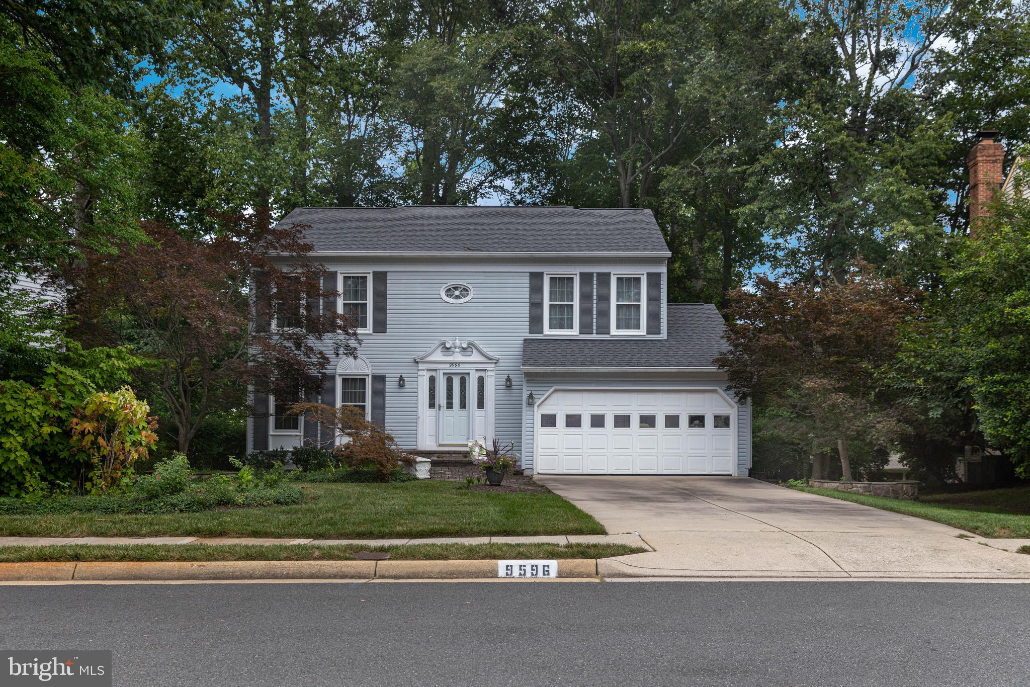 9596 Oakington Drive Fairfax Station, VA 22039 - Photo 1 of 52 a view of a house with a yard and large tree