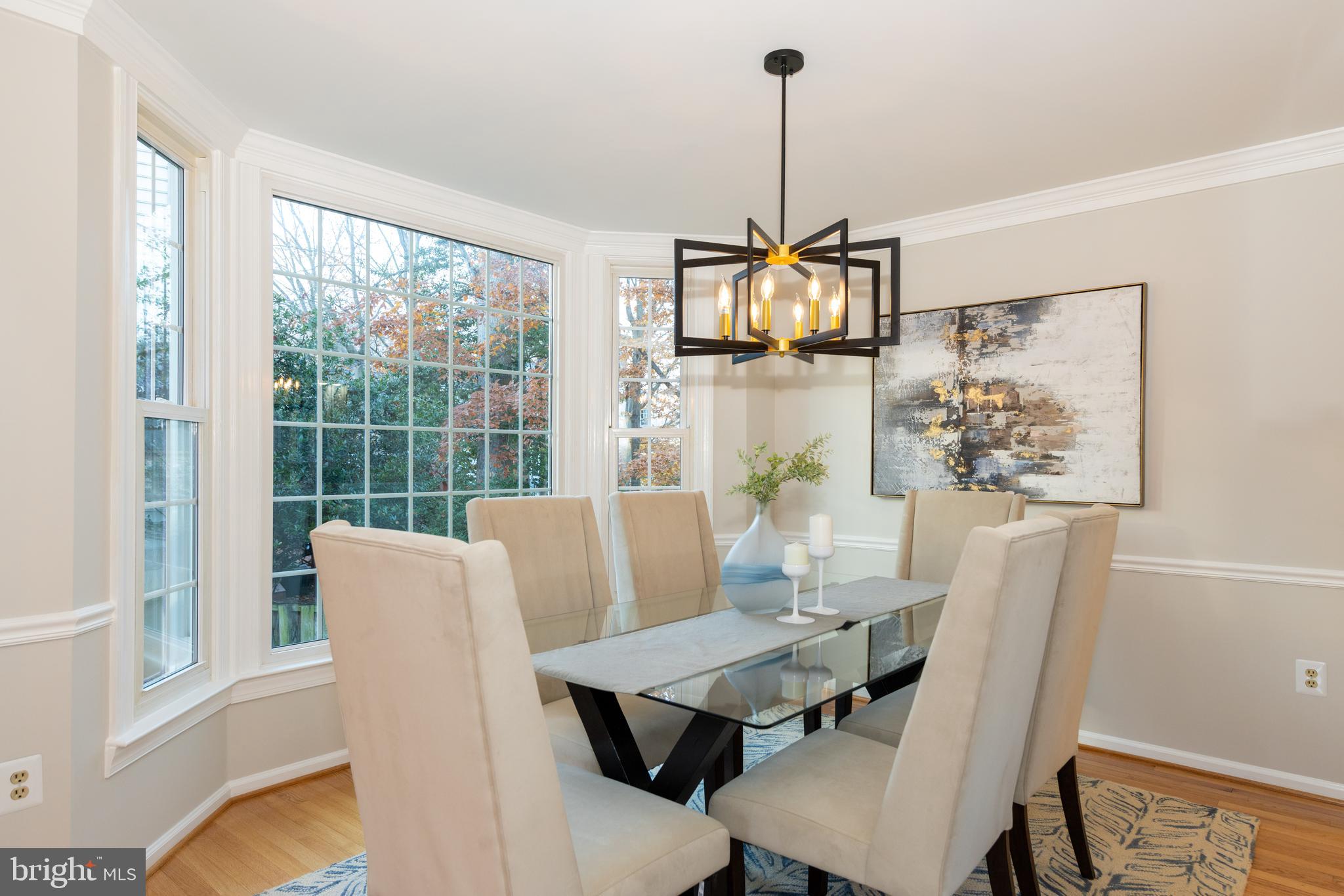 9596 Oakington Drive Fairfax Station, VA 22039 - Photo 12 of 52 a view of a dining room with furniture wooden floor and a chandelier