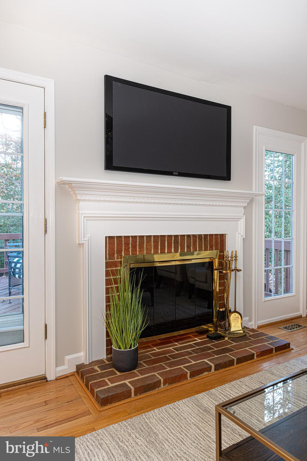 9596 Oakington Drive Fairfax Station, VA 22039 - Photo 13 of 52 a living room with a fireplace and a flat screen tv