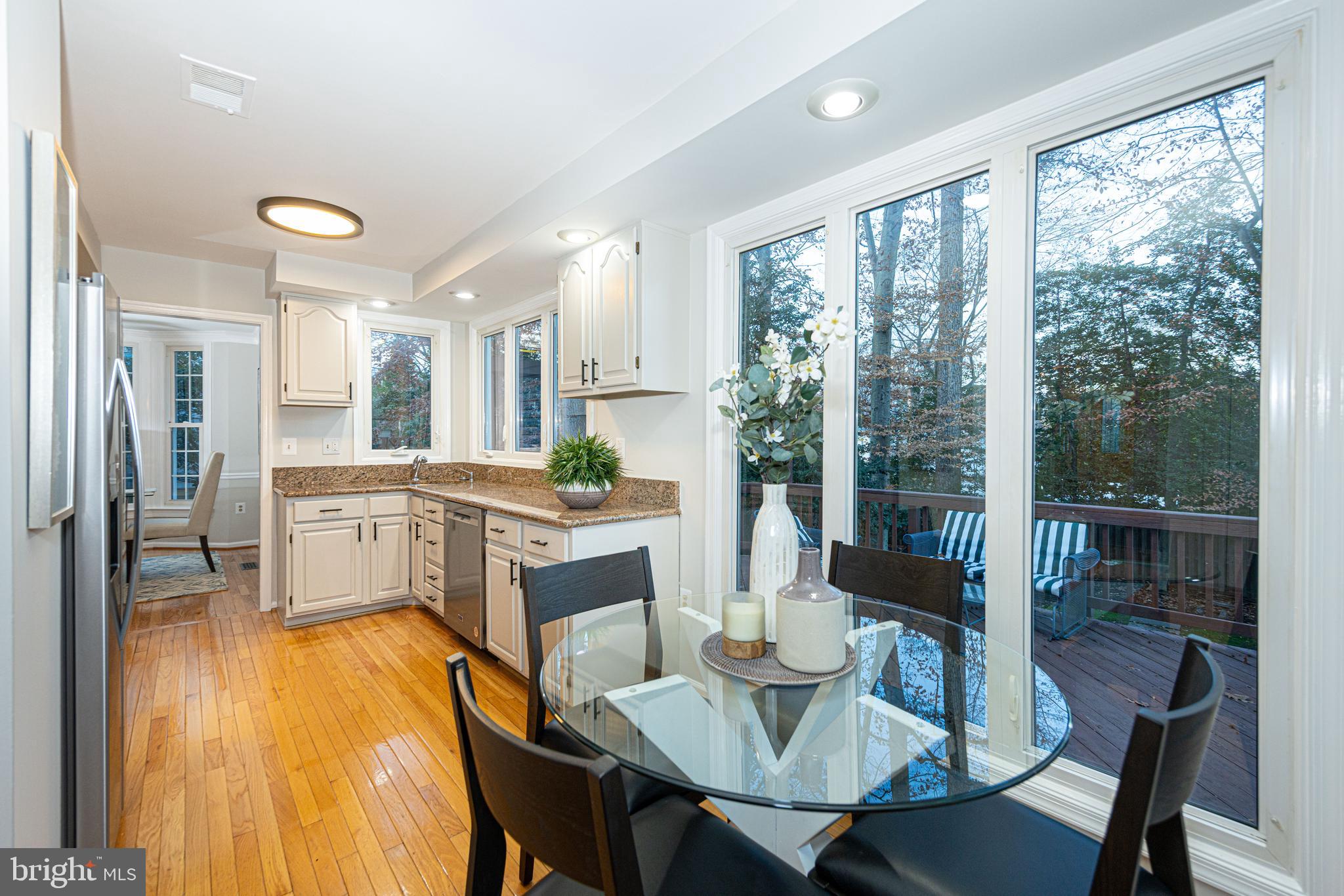9596 Oakington Drive Fairfax Station, VA 22039 - Photo 17 of 52 a dining room with furniture and a floor to ceiling window