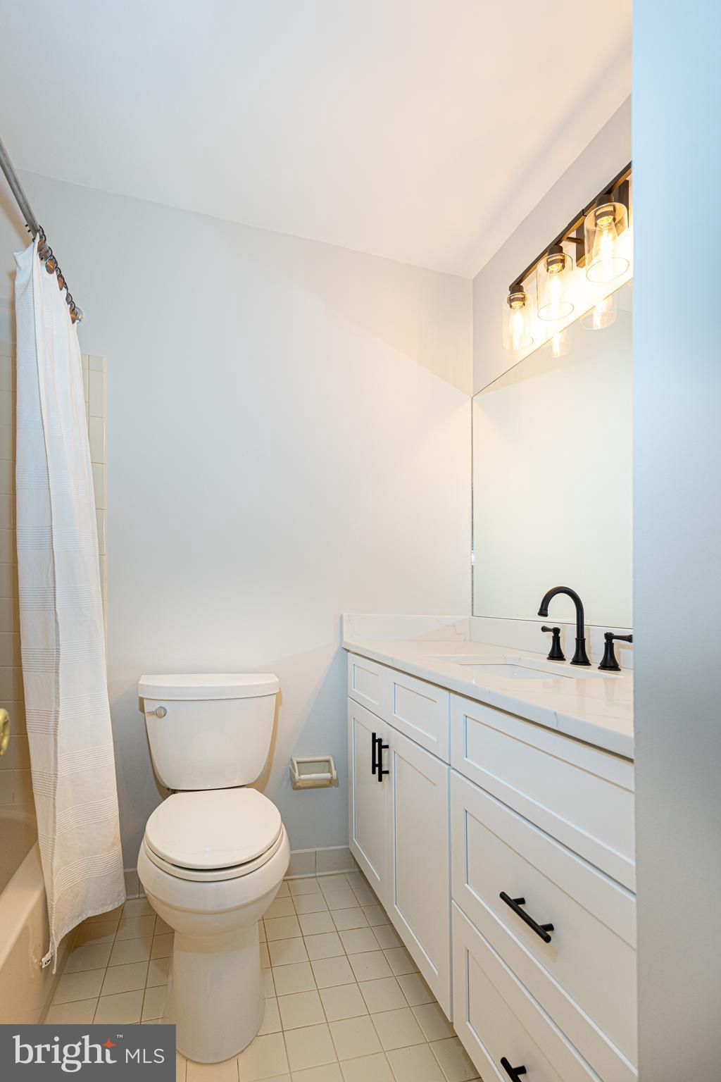 9596 Oakington Drive Fairfax Station, VA 22039 - Photo 19 of 52 a bathroom with a granite countertop toilet sink and mirror