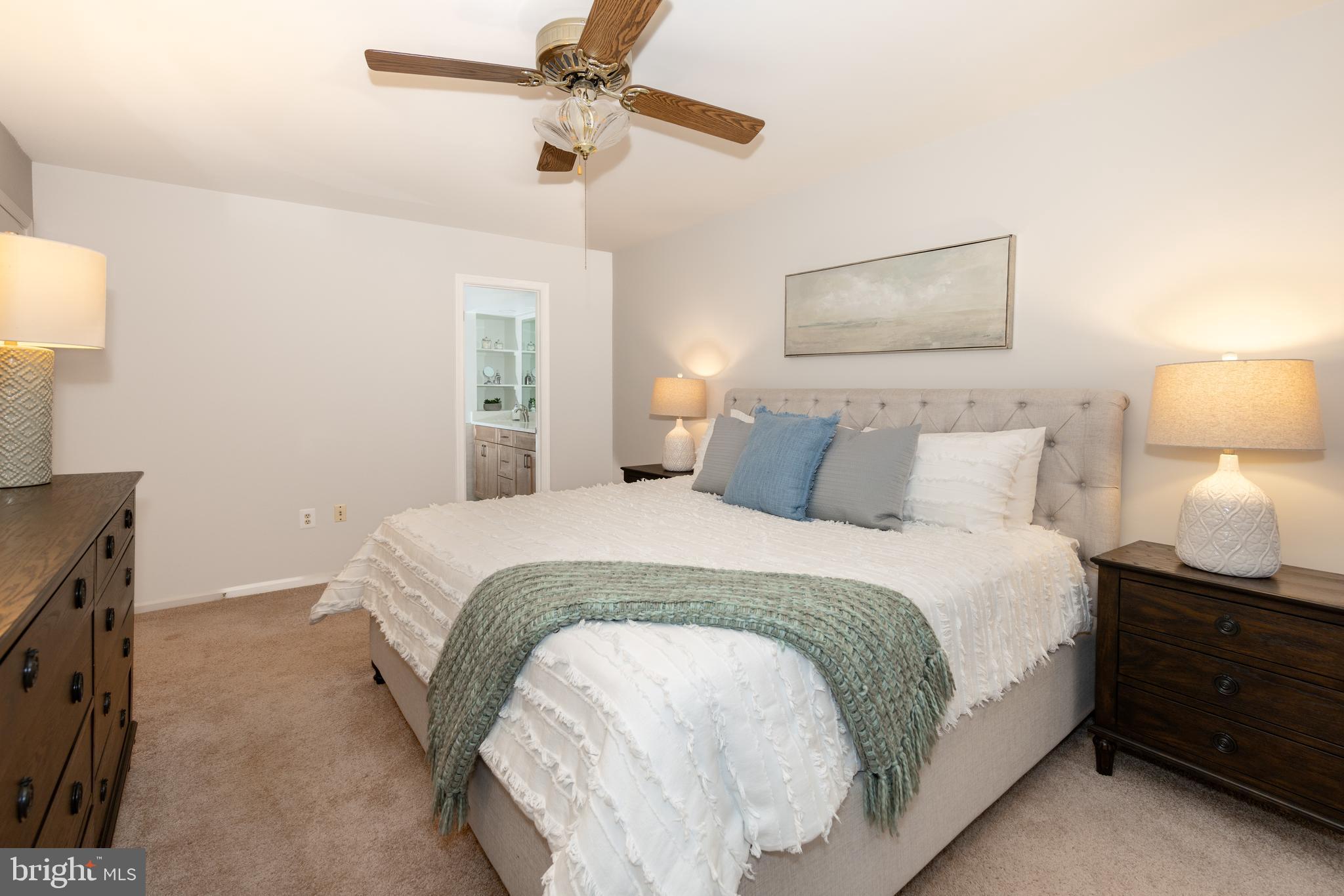 9596 Oakington Drive Fairfax Station, VA 22039 - Photo 22 of 52 a bedroom with a bed and a lamp