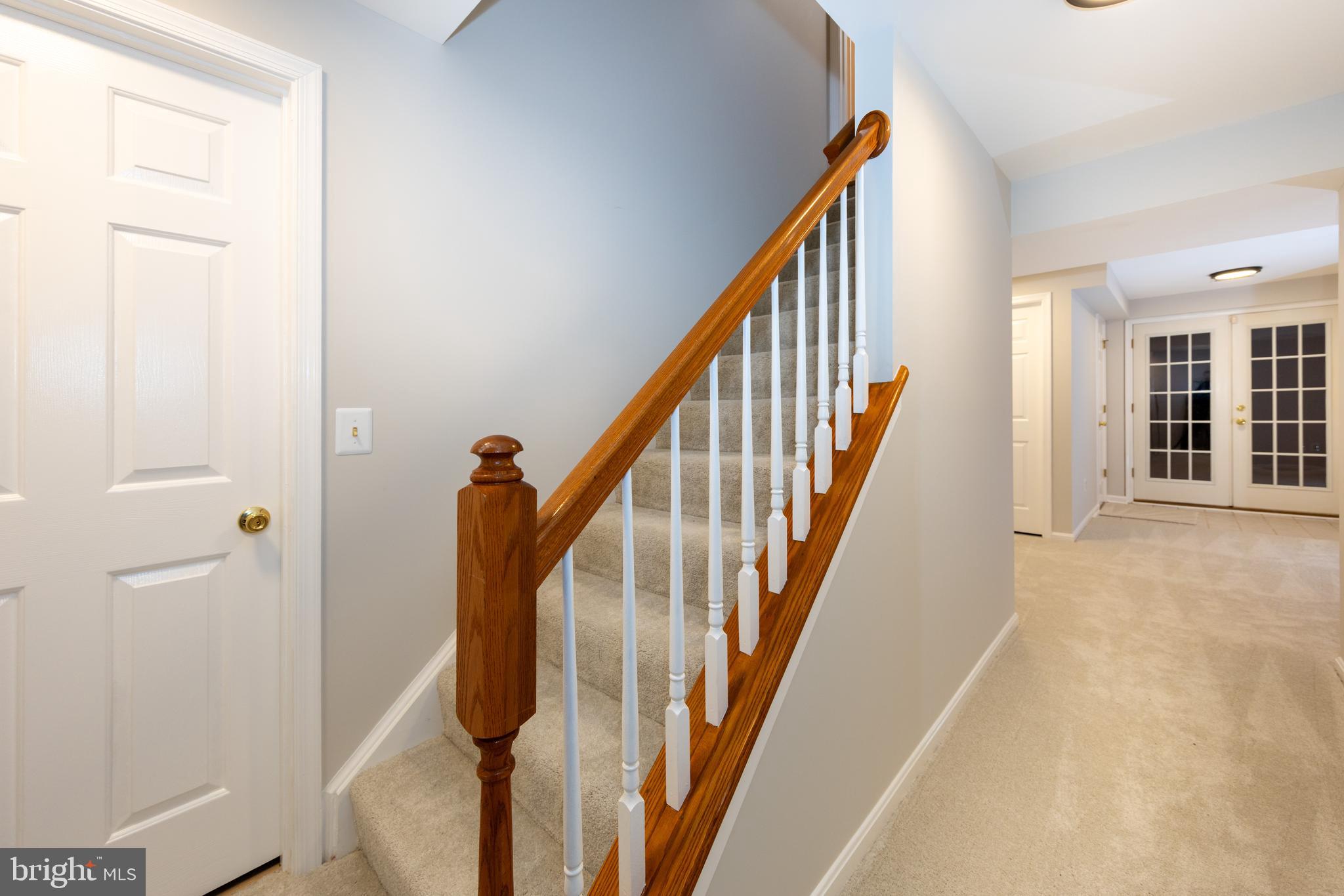 9596 Oakington Drive Fairfax Station, VA 22039 - Photo 31 of 52 a view of a hallway with wooden floor and staircase