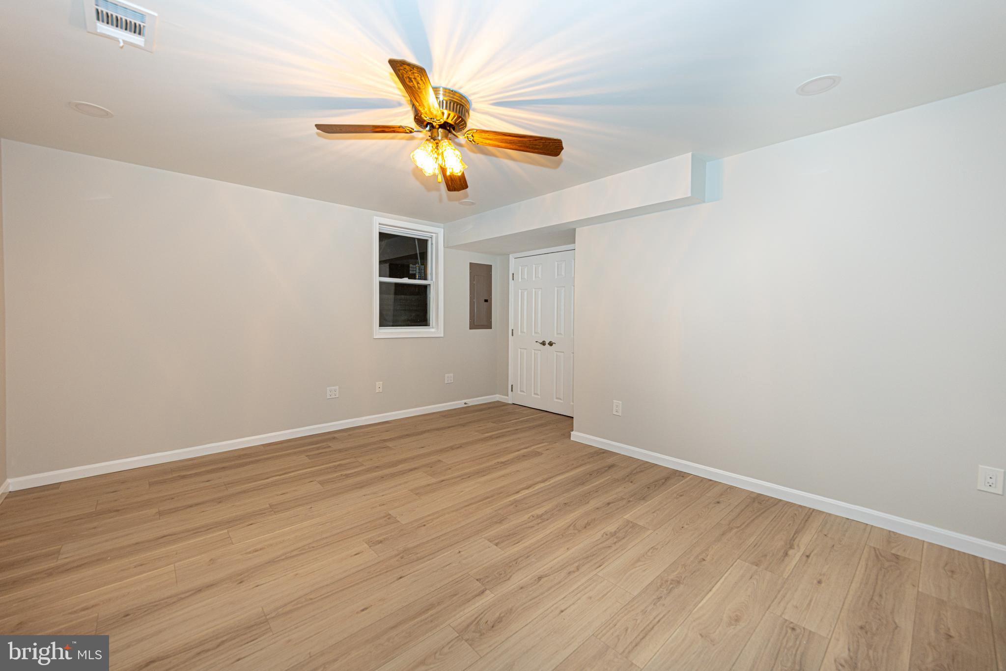 9596 Oakington Drive Fairfax Station, VA 22039 - Photo 32 of 52 an empty room with wooden floor fan and windows