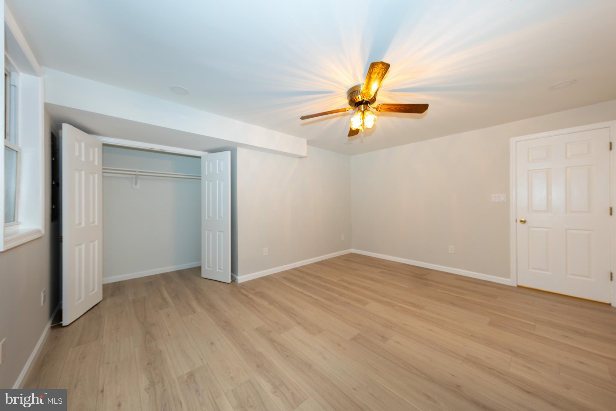 9596 Oakington Drive Fairfax Station, VA 22039 - Photo 33 of 52 an empty room with a window and a ceiling fan