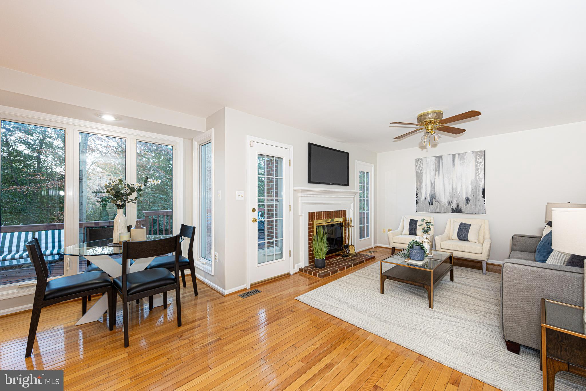 9596 Oakington Drive Fairfax Station, VA 22039 - Photo 3 of 52 a living room with furniture a fireplace and a floor to ceiling window
