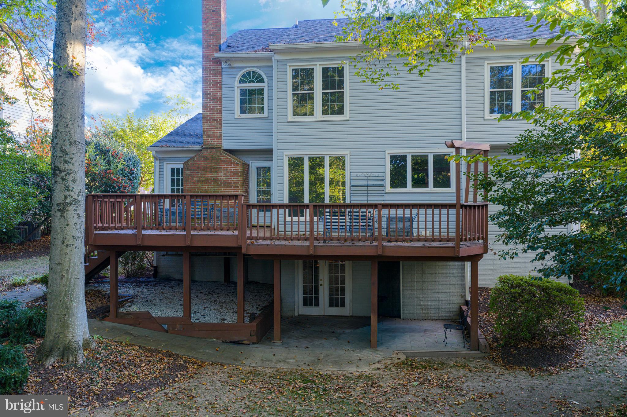 9596 Oakington Drive Fairfax Station, VA 22039 - Photo 44 of 52 a view of house with a wooden deck and furniture