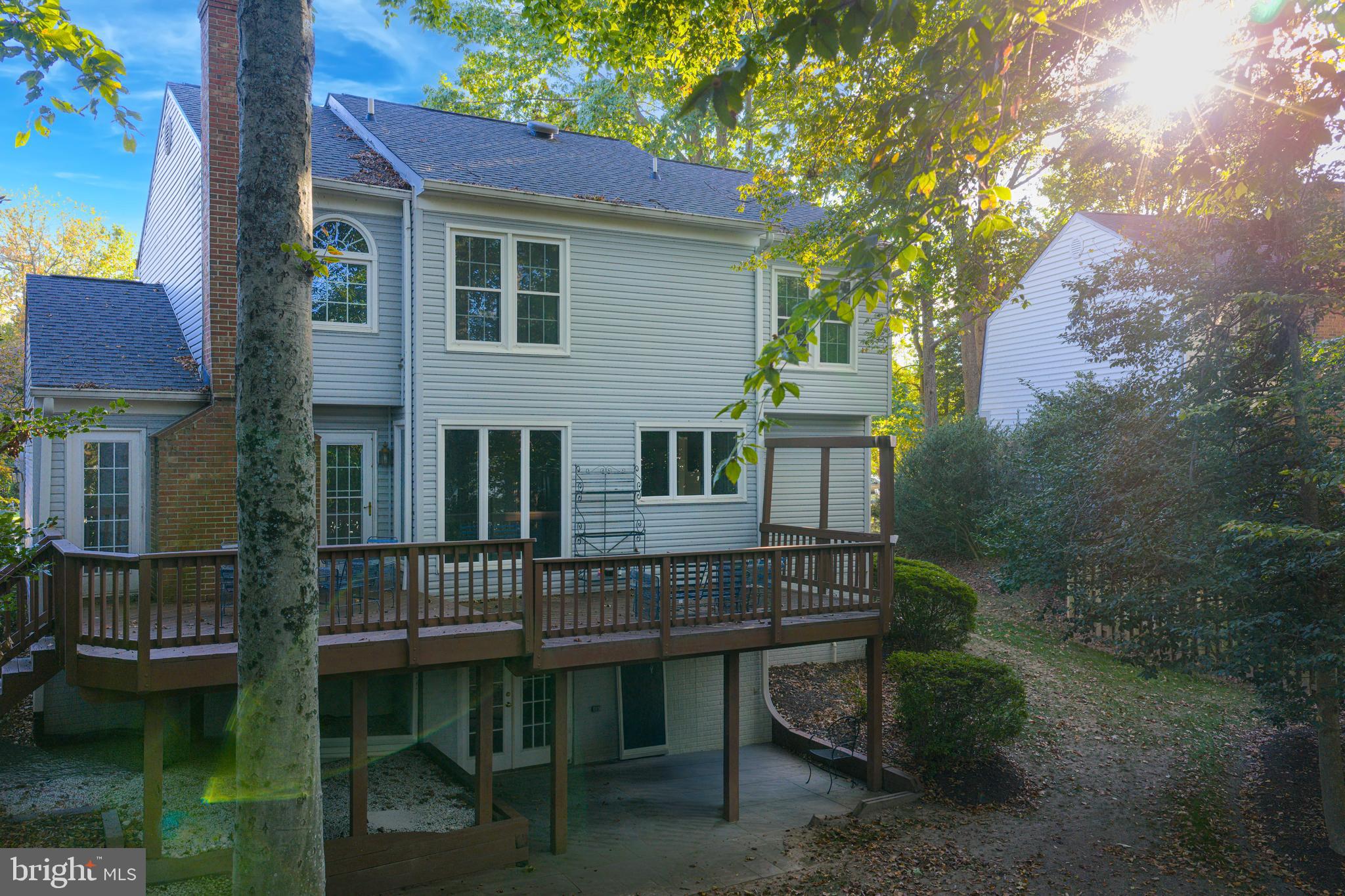9596 Oakington Drive Fairfax Station, VA 22039 - Photo 6 of 52 a backyard of a house with table and chairs
