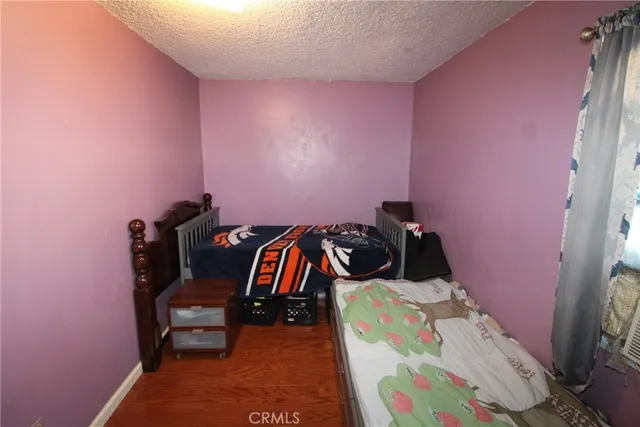 a bedroom with bed and a mirror